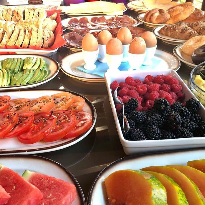 Breakfast with fruits, eggs and pastries